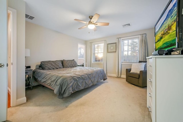 bedroom featuring ceiling fan and light carpet