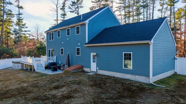 back of house with a yard and a wooden deck