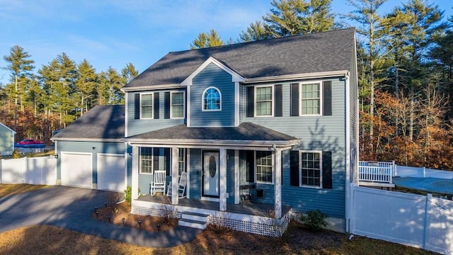 colonial house with covered porch and a garage