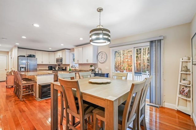 dining space featuring sink and light wood-type flooring