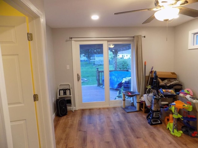 doorway featuring wood finished floors, a ceiling fan, and recessed lighting