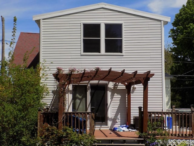 back of house featuring a deck and a pergola