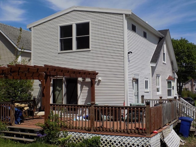 back of house featuring a pergola and a wooden deck