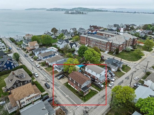 drone / aerial view featuring a water view and a residential view