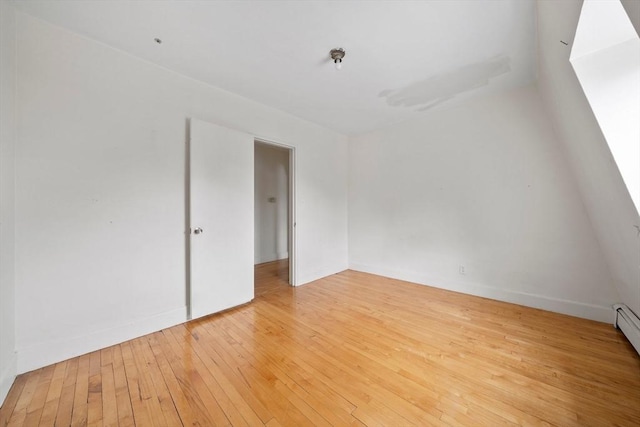 unfurnished room with baseboards and light wood-style floors