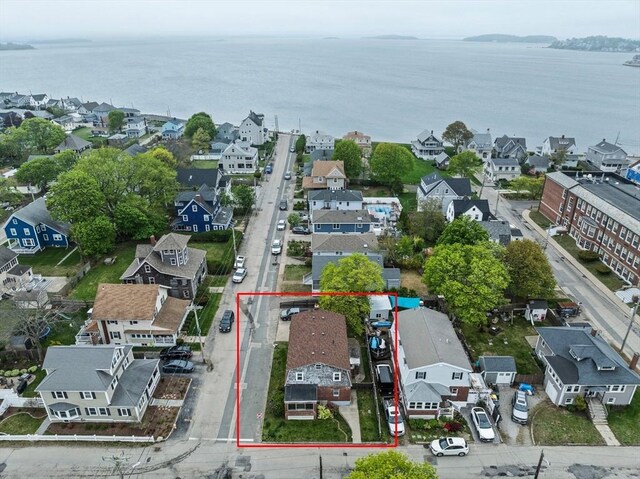 drone / aerial view featuring a water view and a residential view