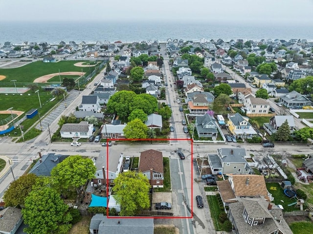 birds eye view of property with a water view and a residential view