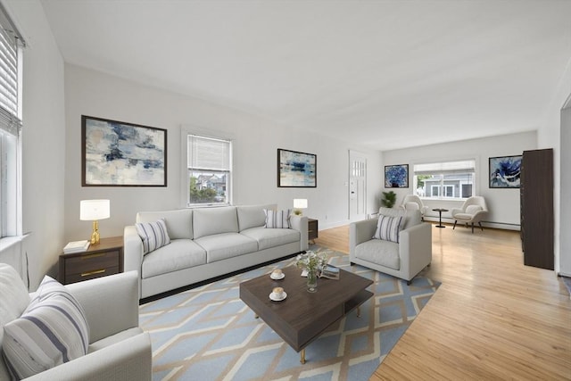 living area featuring baseboards and light wood-type flooring