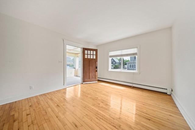 interior space featuring baseboards, hardwood / wood-style floors, and baseboard heating