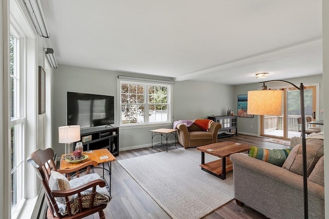 living area featuring wood finished floors and baseboards