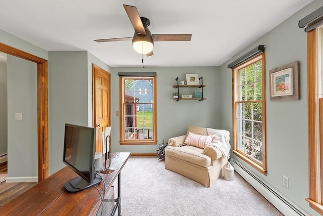 sitting room featuring baseboard heating, ceiling fan, and baseboards