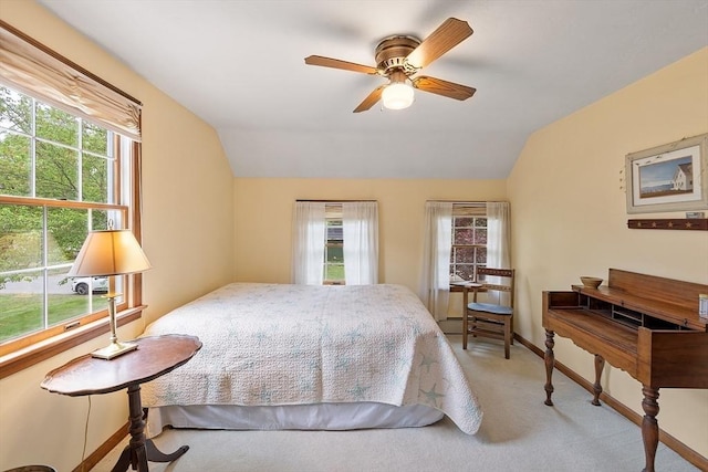 carpeted bedroom featuring lofted ceiling and baseboards