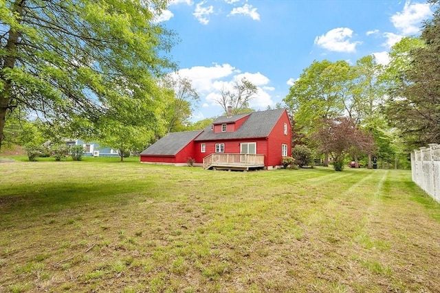 view of green lawn with a deck