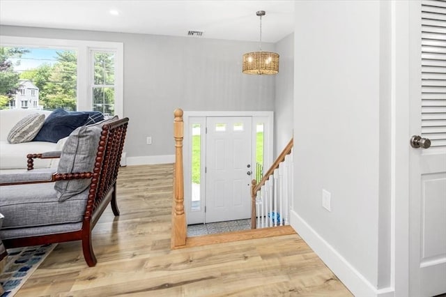 entrance foyer featuring light wood-style floors, baseboards, and recessed lighting