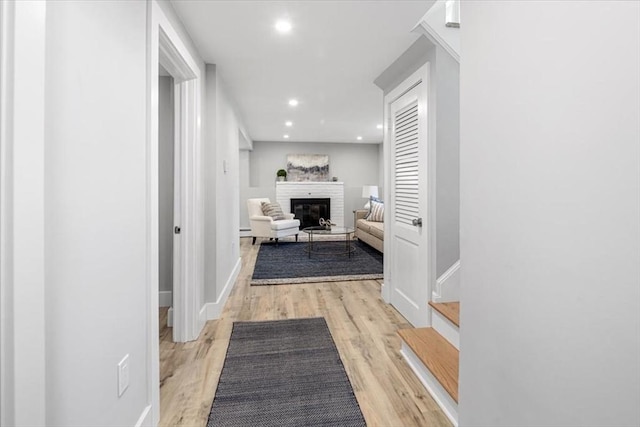 hallway with wood finished floors, recessed lighting, and baseboards