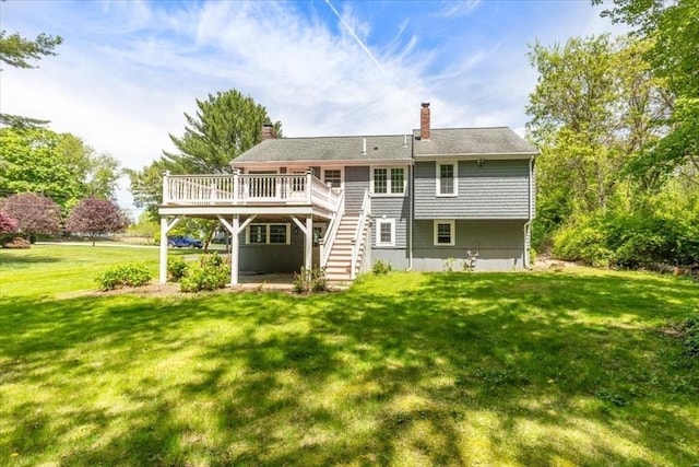 rear view of house with stairs, a wooden deck, a lawn, and a chimney