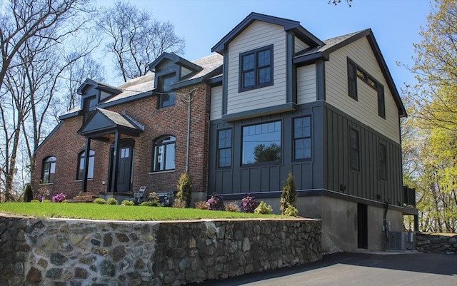 6 Lovis Ave, Wakefield, MA 01880 - view of front of house featuring board and batten siding, brick siding, and central AC