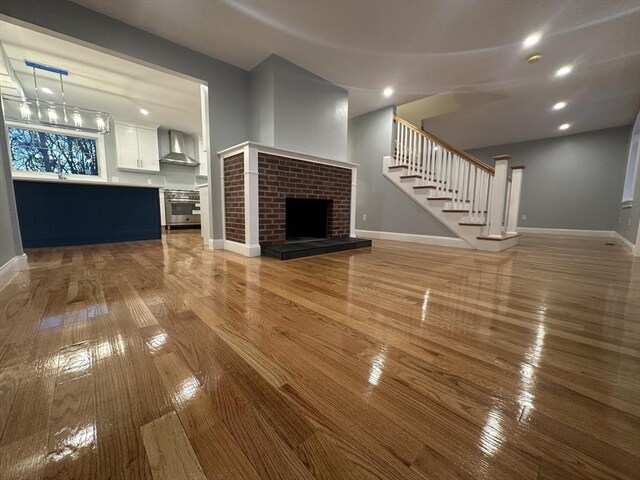 6 Lovis Ave, Wakefield, MA 01880 - unfurnished living room featuring wood-type flooring, stairs, and baseboards