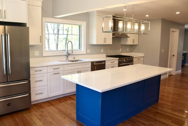 6 Lovis Ave, Wakefield, MA 01880 - kitchen with a sink, wood finished floors, light countertops, under cabinet range hood, and appliances with stainless steel finishes