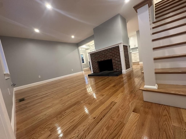6 Lovis Ave, Wakefield, MA 01880 - unfurnished living room with light wood-style flooring, baseboards, visible vents, recessed lighting, and a fireplace