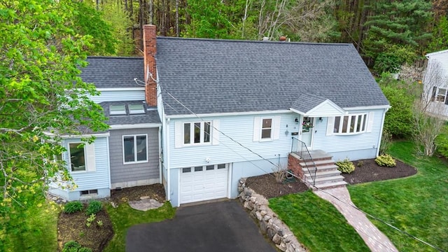 view of front of house featuring driveway, a chimney, roof with shingles, and a garage