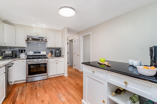 kitchen with white cabinetry, under cabinet range hood, and stainless steel appliances