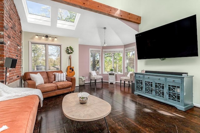 living area with a skylight, wood-type flooring, beam ceiling, and a wealth of natural light