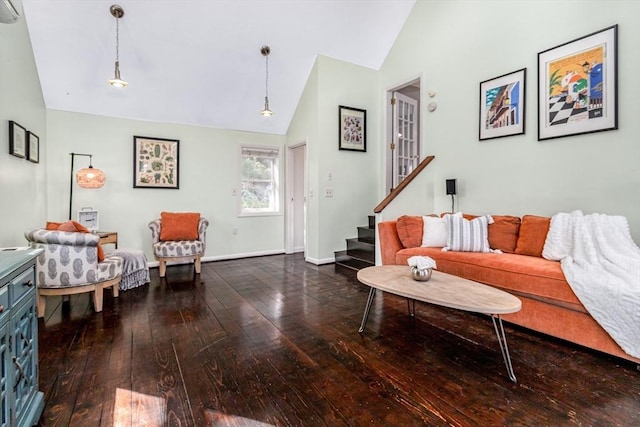 living area featuring baseboards, stairs, high vaulted ceiling, and hardwood / wood-style floors