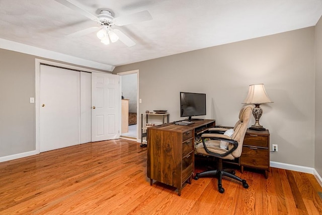 home office with baseboards, light wood-style floors, and ceiling fan