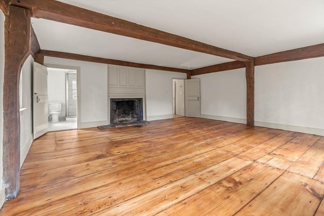 unfurnished living room with a fireplace and light wood-type flooring