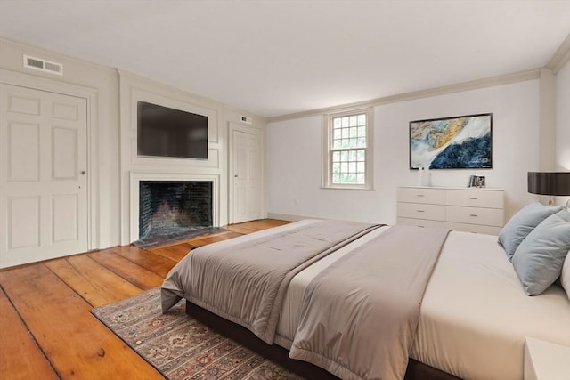 bedroom featuring hardwood / wood-style flooring and ornamental molding