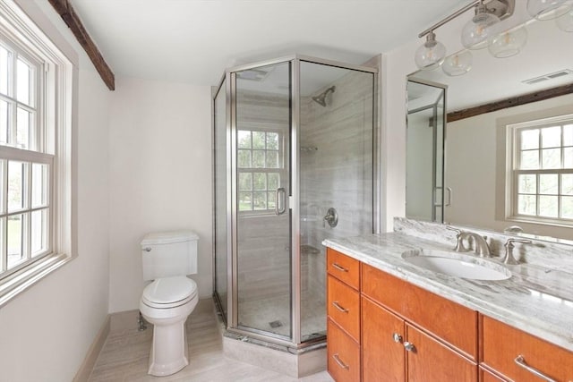 bathroom featuring tile patterned floors, vanity, toilet, and an enclosed shower