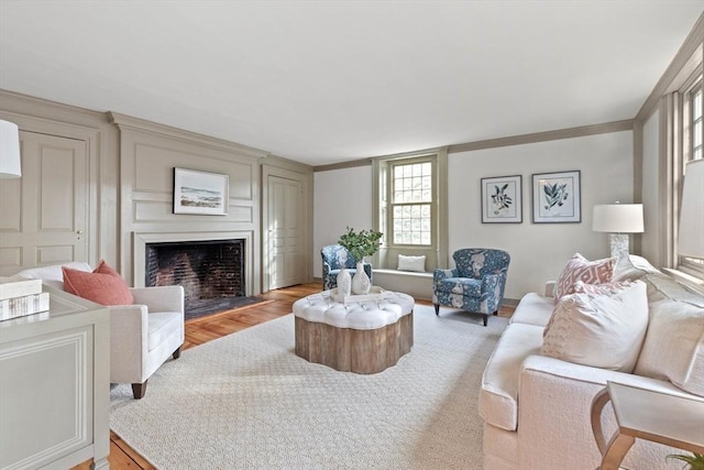 living room with hardwood / wood-style flooring and ornamental molding