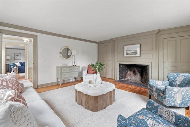 living room with crown molding and light wood-type flooring