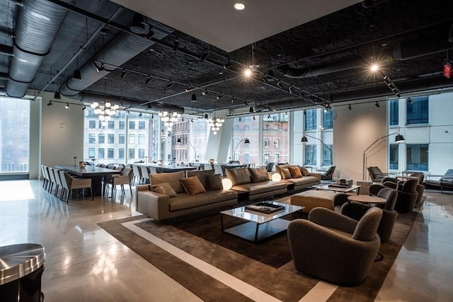 240 Devonshire St Unit 3708, Boston, MA 02110 - living area with a chandelier, track lighting, floor to ceiling windows, healthy amount of natural light, and concrete floors