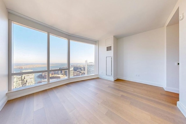 240 Devonshire St Unit 3708, Boston, MA 02110 - unfurnished room featuring plenty of natural light, light wood-style flooring, and baseboards