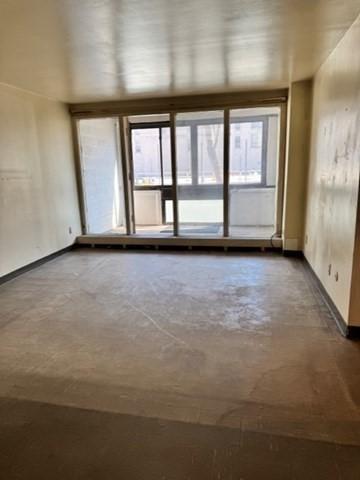 unfurnished room featuring concrete flooring