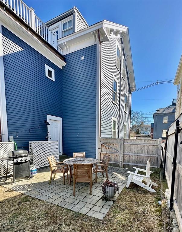 back of house with a patio area and fence