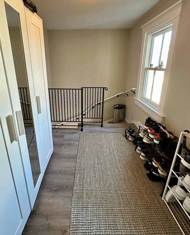 interior space featuring dark wood finished floors and an upstairs landing