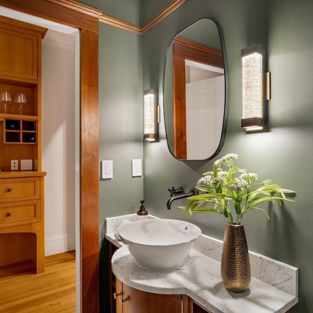 bathroom with wood finished floors and vanity