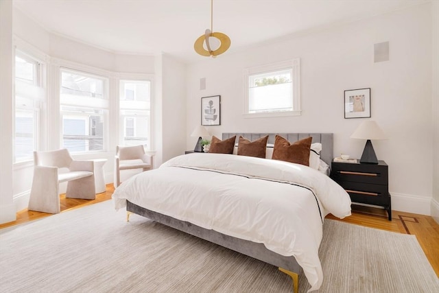 bedroom featuring baseboards and wood finished floors