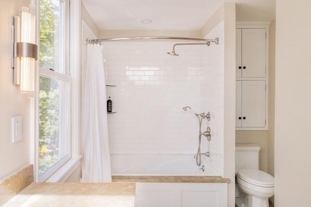 bathroom featuring toilet and shower / bathtub combination with curtain