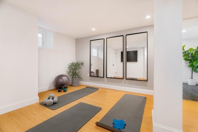 workout area with recessed lighting, wood finished floors, and baseboards