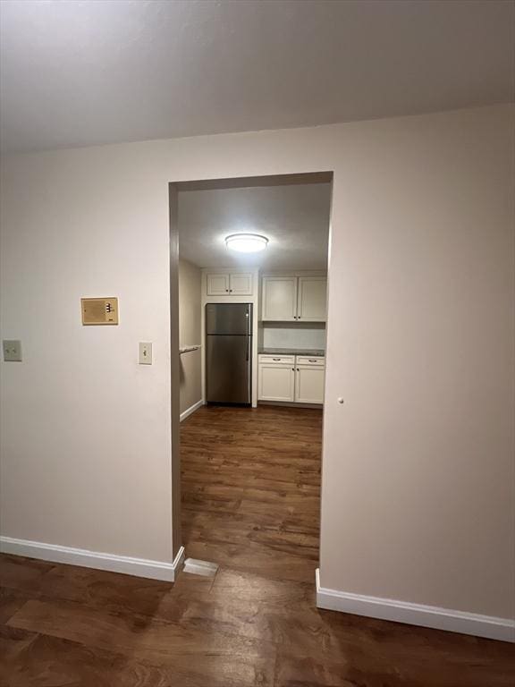 9 Broadway Unit 210, Saugus, MA 01906 - hallway with baseboards and dark wood-style floors