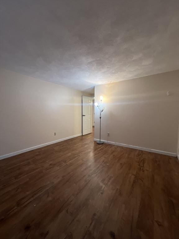 9 Broadway Unit 210, Saugus, MA 01906 - empty room with baseboards and dark wood-style flooring