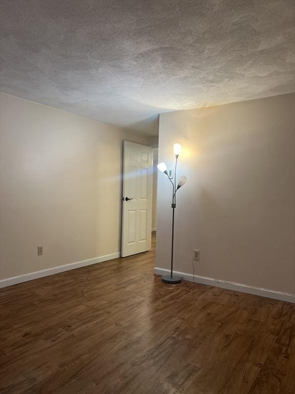 9 Broadway Unit 210, Saugus, MA 01906 - unfurnished room with dark wood finished floors and a textured ceiling
