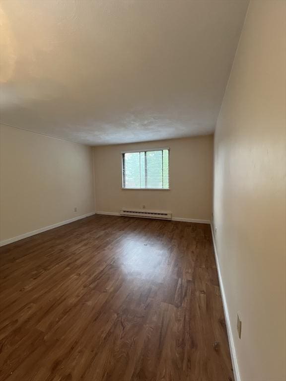 9 Broadway Unit 210, Saugus, MA 01906 - empty room with a baseboard radiator and wood finished floors