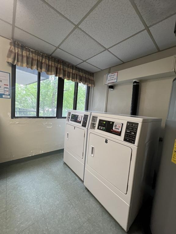 9 Broadway Unit 210, Saugus, MA 01906 - communal laundry room featuring washing machine and clothes dryer, tile patterned floors, and water heater
