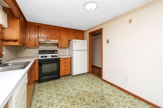 kitchen featuring tasteful backsplash, sink, and white appliances