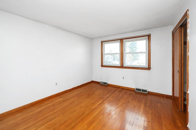 unfurnished bedroom featuring wood-type flooring and a closet